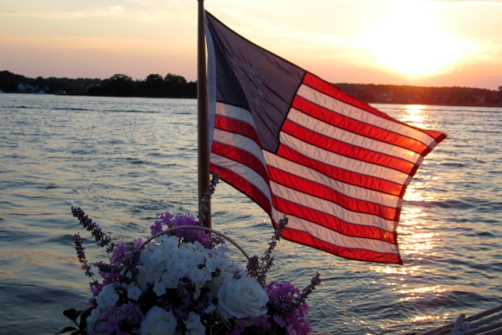 american flag and flowers on the back of the boat
