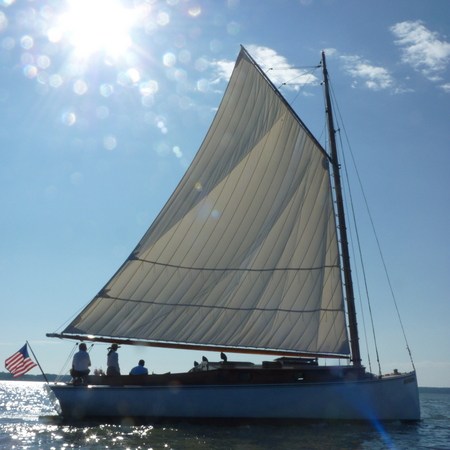 Embrace the wonder and awe of nature aboard a private charter with Sail Selina in St. Michaels, MD - This spectacular image captures the magic and serenity of a glittering sun on the tranquil waters of the Chesapeake Bay - Book your private Sail Selina adventure today