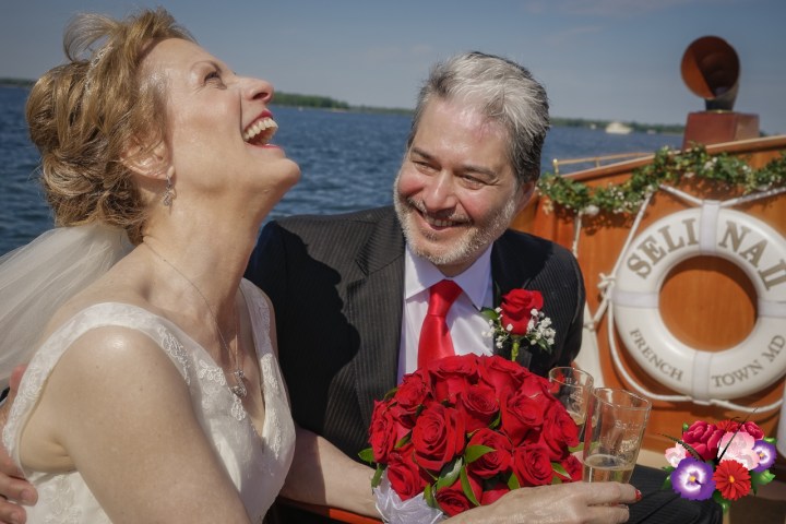 Find love and happiness once again with a nautical wedding or elopement aboard Sail Selina in St. Michaels, MD - Capture the passion and serenity of a couple in love, just like this couple with the stunning red rose bouquet - Book your Sail Selina boat wedding now!