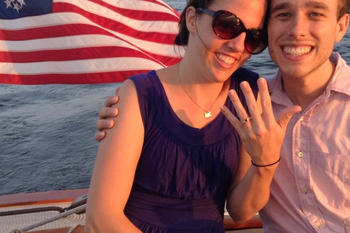 Celebrate the love and adventure of your engagement with Sail Selina, the premier venue for engagement cruises in St. Michaels, MD - This lovely image showcases the playful and intimate moments between couples, embracing the romance and excitement of their special day - Book your Sail Selina adventure today and make unforgettable memories with your love!