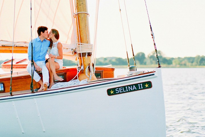 Capture the enchanting and unforgettable moments of your engagement with Sail Selina's stunning engagement cruises in St. Michaels, MD - This captivating image features a couple in love enjoying the serenity and beauty of their journey on-board Sail Selina - Start your adventure with Sail Selina and make the ultimate moments last forever!