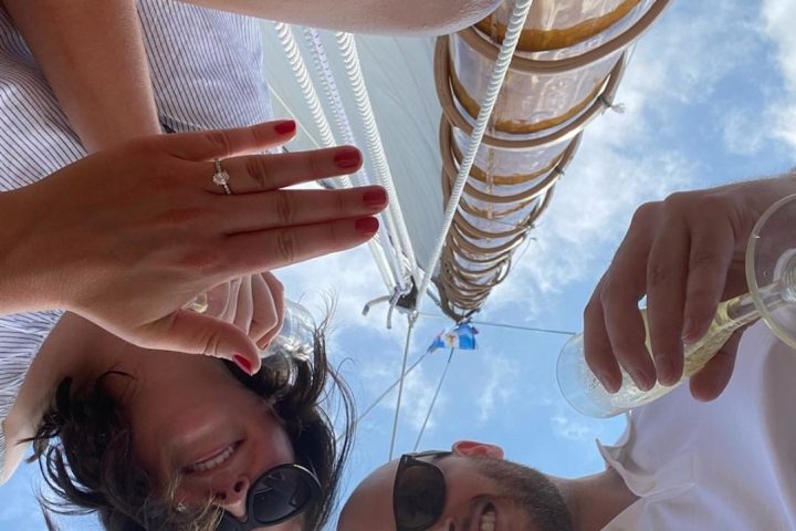 Experience the joy and passion of your engagement day with Sail Selina's private cruises in St. Michaels, MD - This enchanting image showcases the romantic and playful moments between couples, surrounded by the stunning Chesapeake Bay views - Start your engagement journey with Sail Selina and capture the magic of your special day