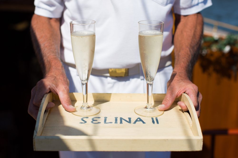 Experience a stunning sunset over the Chesapeake Bay with Sail Selina's Sunset Tour crew in St. Michaels - our first mate serves a tray of fantastic bubbly, the perfect addition to end your day - Book your experience now