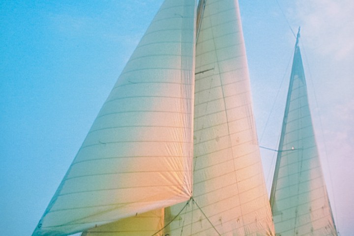 Sailboat named 'Lady Patty' sailing on a clear day with an American flag on the stern.