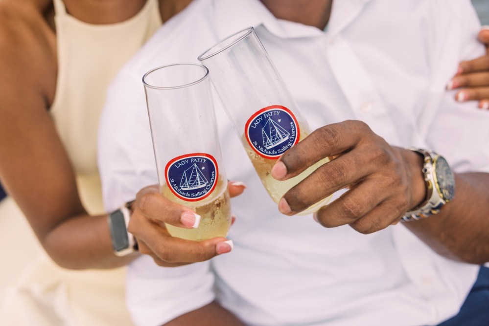 Couple toasting with custom champagne glasses.