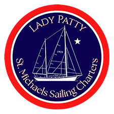 Circular logo with sailboat and text: 'Lady Patty, St. Michaels Sailing Charters.'